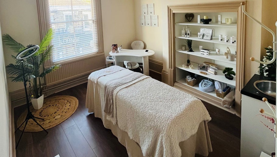 Serene massage room at Xela Massage and Skincare, Cottingham, England, GB with cozy decor and skincare products.