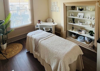 Serene massage room at Xela Massage and Skincare, Cottingham, England, GB with cozy decor and skincare products.