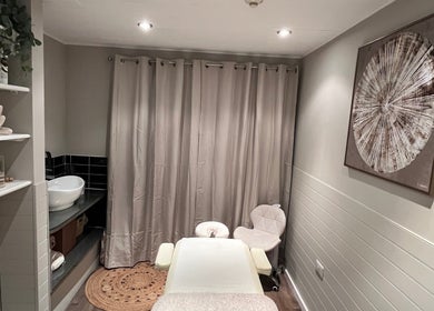 Relaxing massage room at Xela Massage and Recovery in Willerby, England, GB with soft lighting and elegant decor.