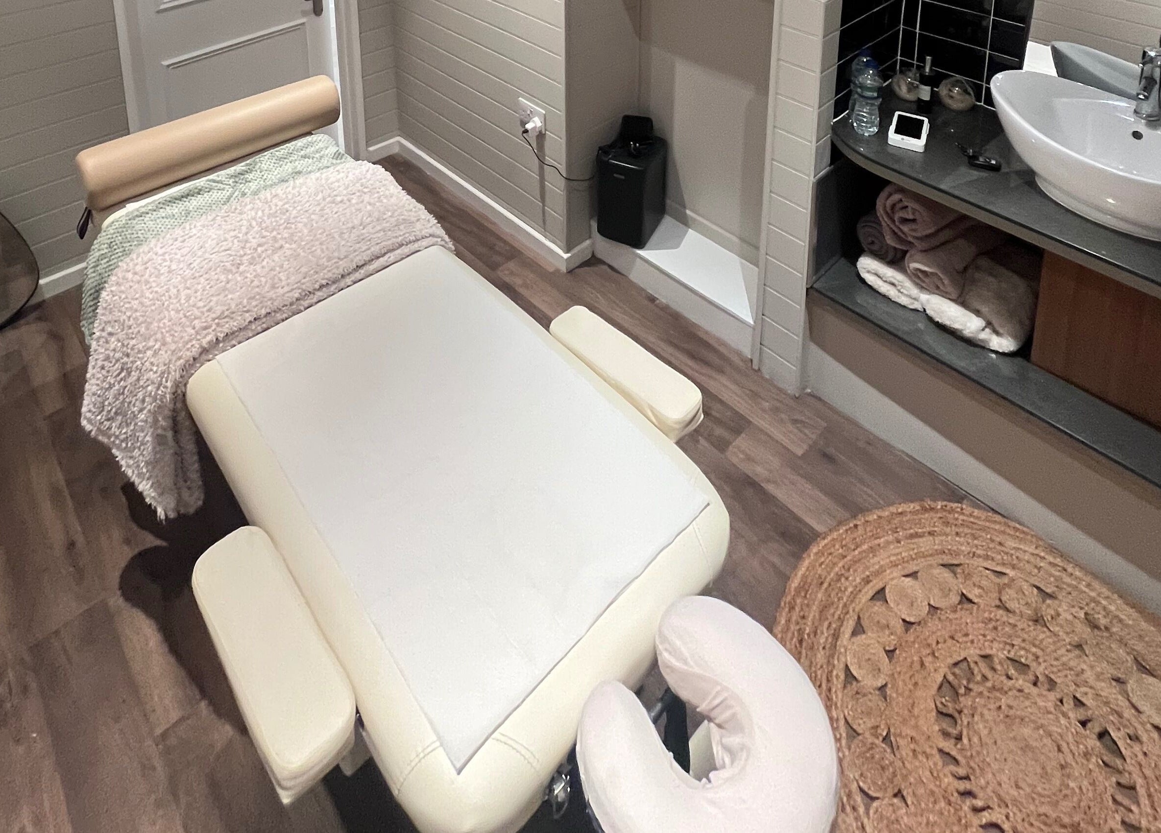 Massage room at Xela Massage and Recovery, Willerby, England, GB. Cozy setup with a plush massage table and warm decor.