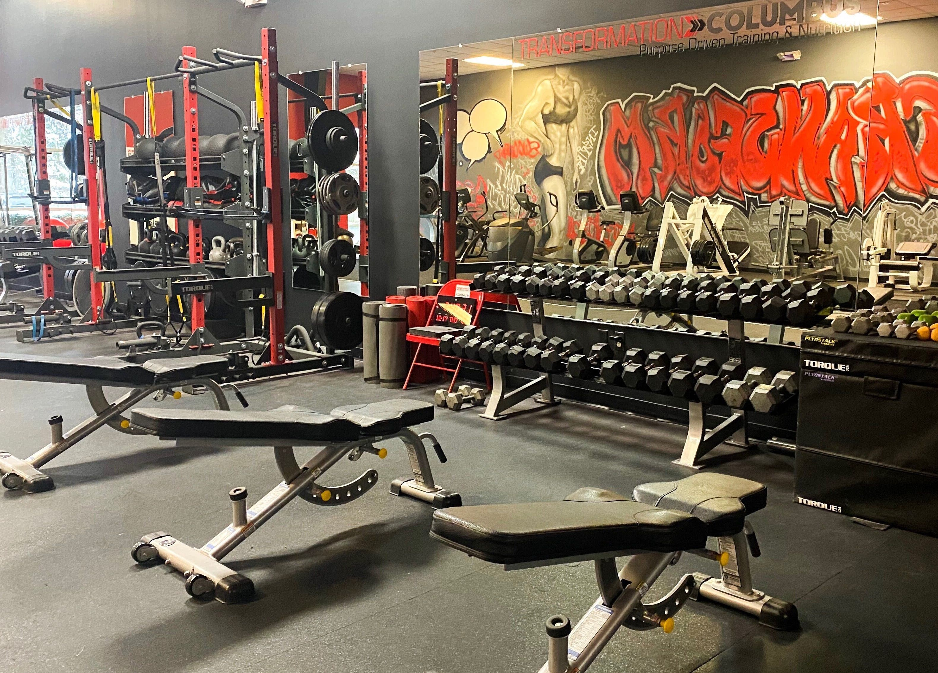 Gym equipment at Transformation Columbus in Powell, Ohio, US. Features benches and weights for a robust workout.