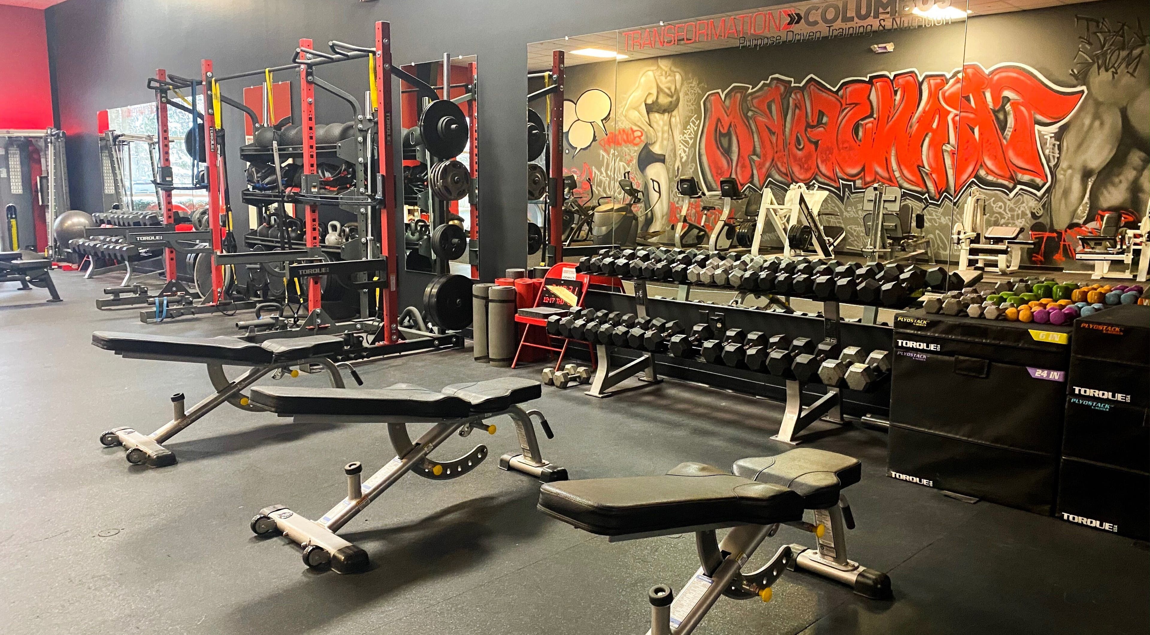 Gym equipment at Transformation Columbus in Powell, Ohio, US. Features benches and weights for a robust workout.