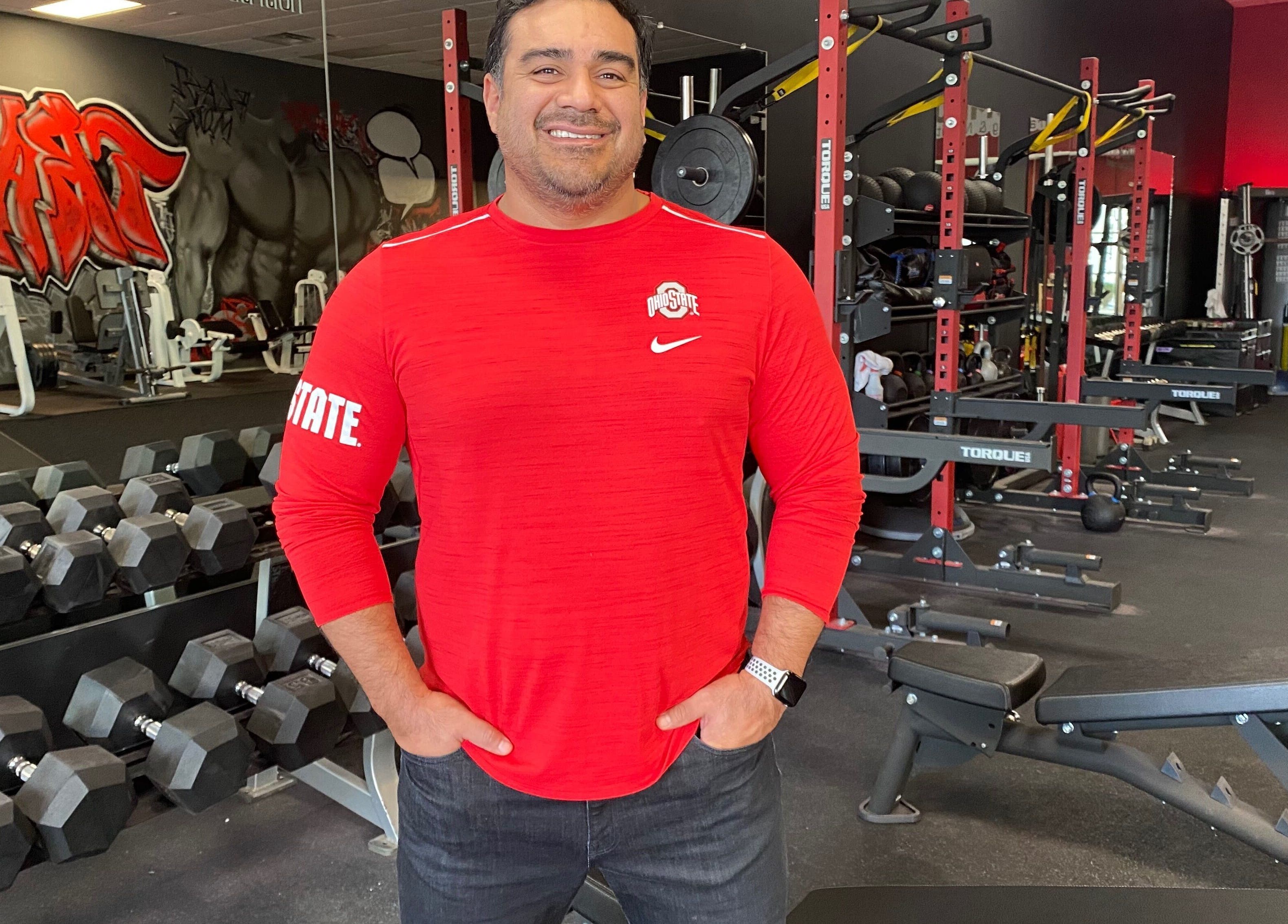 Trainer at Transformation Columbus gym in Powell, Ohio, US amid modern fitness equipment.