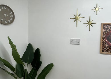 Stylish decor at BABE Aesthetics in Billingham, England, GB, featuring plants, art, and gold stars.