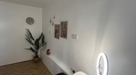Serene corner at BABE Aesthetics, Billingham, England, GB with a plant, wall art, and stylish decor.