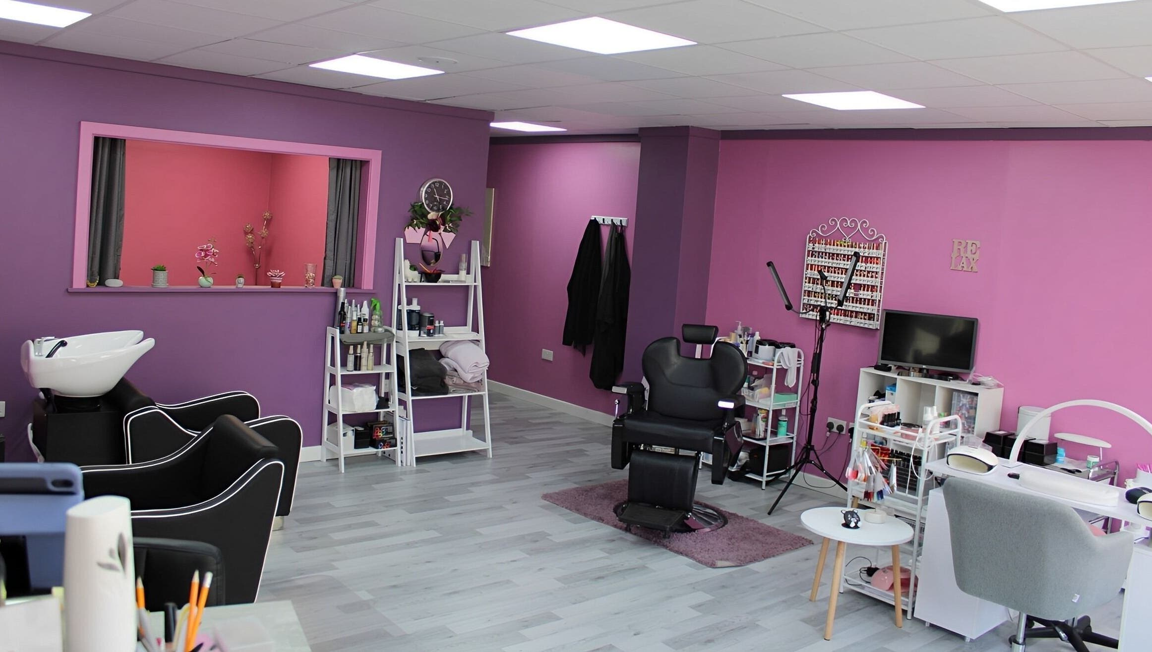GlamMary's vibrant salon interior in Wallsend, England, GB with sleek chairs and nail stations.