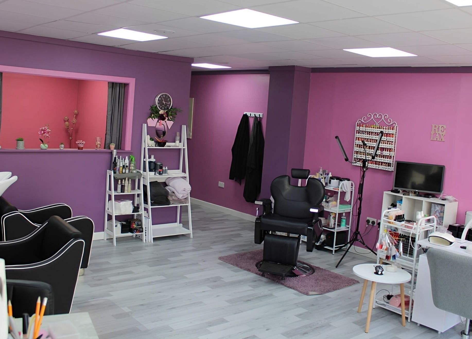 GlamMary's vibrant salon interior in Wallsend, England, GB with sleek chairs and nail stations.