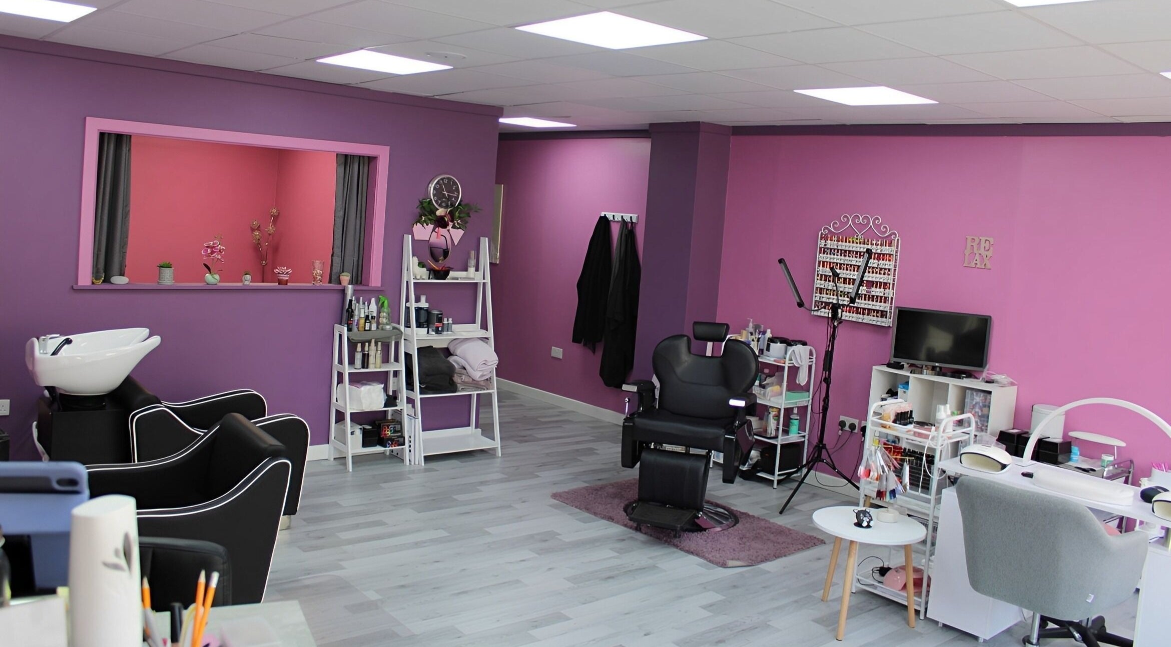 GlamMary's vibrant salon interior in Wallsend, England, GB with sleek chairs and nail stations.
