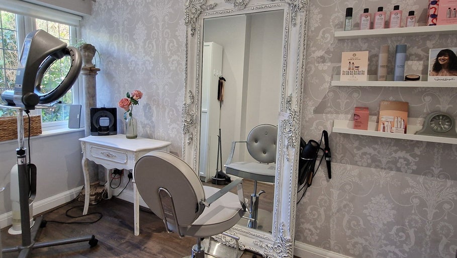 Chic salon interior featuring a large ornate mirror at Scarlett Valentine Hair, Epsom, England, GB.