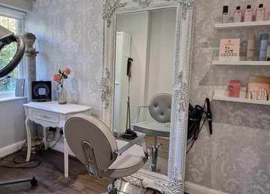Chic salon interior featuring a large ornate mirror at Scarlett Valentine Hair, Epsom, England, GB.