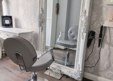 Chic salon chair and ornate mirror at Scarlett Valentine Hair in Epsom, England, GB.