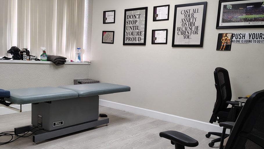 Therapy room at Redefined Physique, Irving, Texas, US with a treatment table and motivational decor.