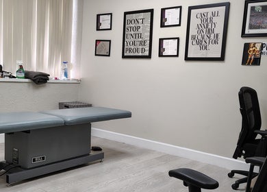 Therapy room at Redefined Physique, Irving, Texas, US with a treatment table and motivational decor.