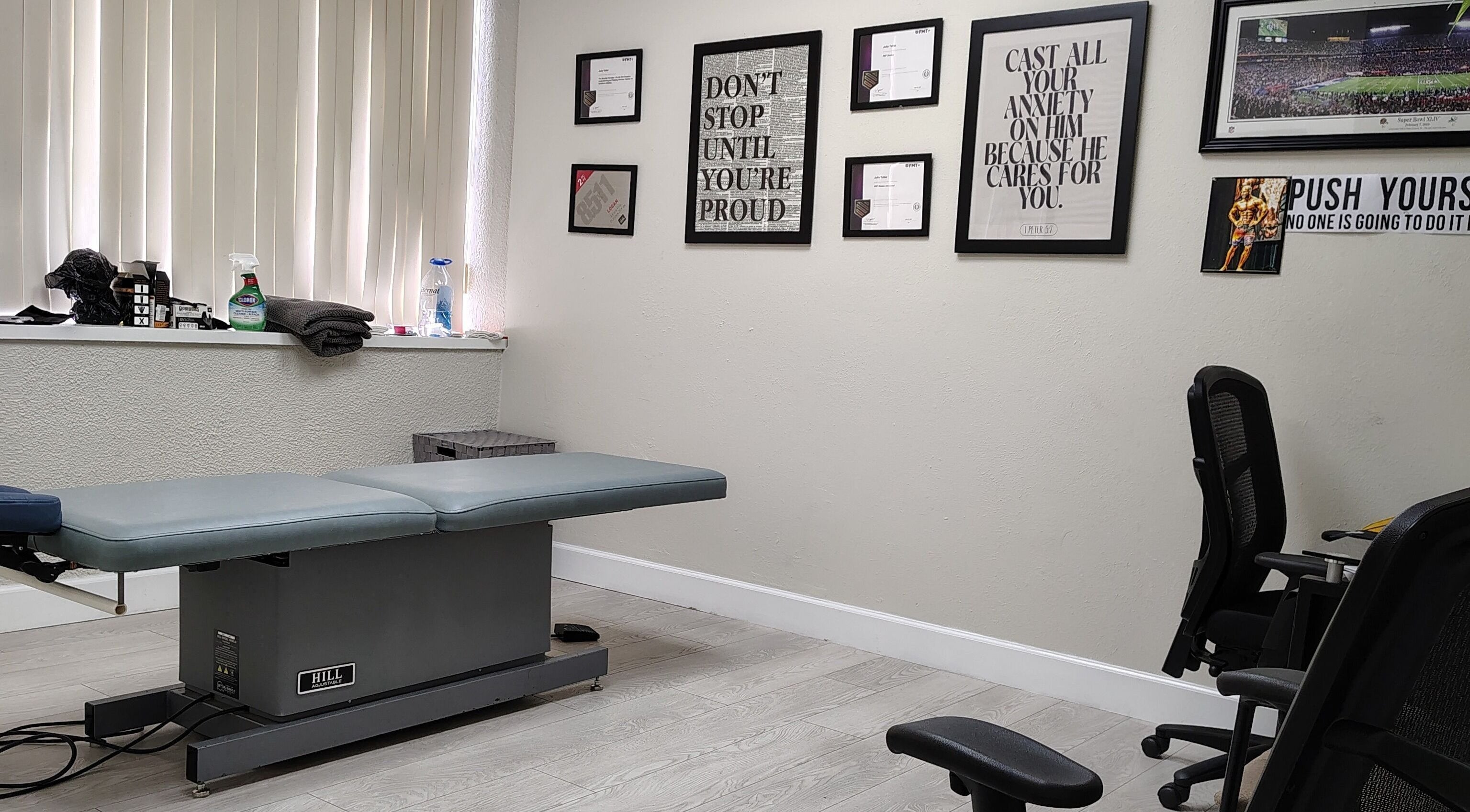 Therapy room at Redefined Physique, Irving, Texas, US with a treatment table and motivational decor.