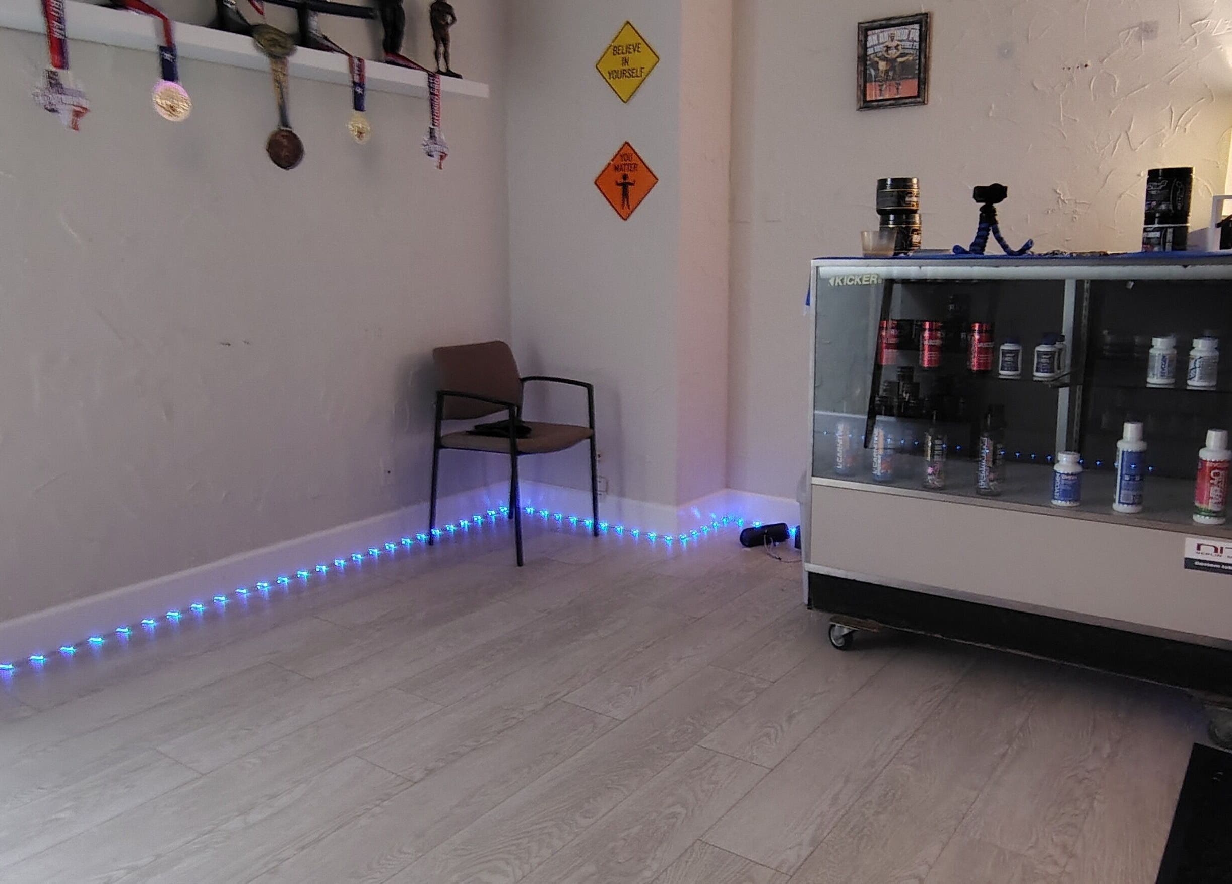 Redefined Physique in Irving, Texas showcases a cozy corner with medals and wellness products.