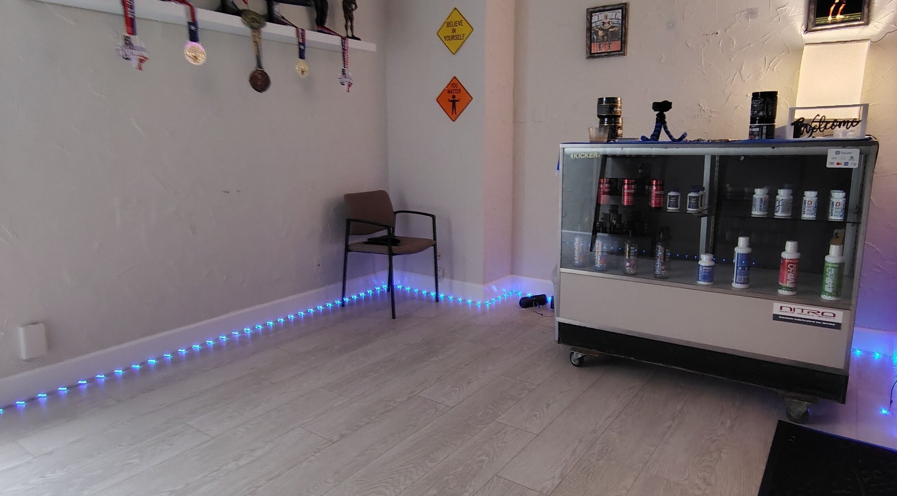 Redefined Physique in Irving, Texas showcases a cozy corner with medals and wellness products.