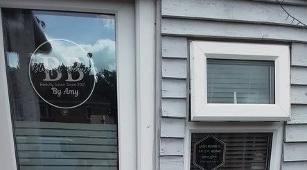 Blissful Beauty salon entrance in Taunton, England with stylish signage alongside window.