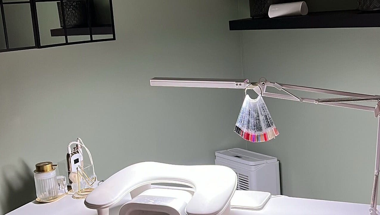 Modern nail station at Nails by Cat, Cambuslang, Scotland, GB, showcasing tools and polish samples.