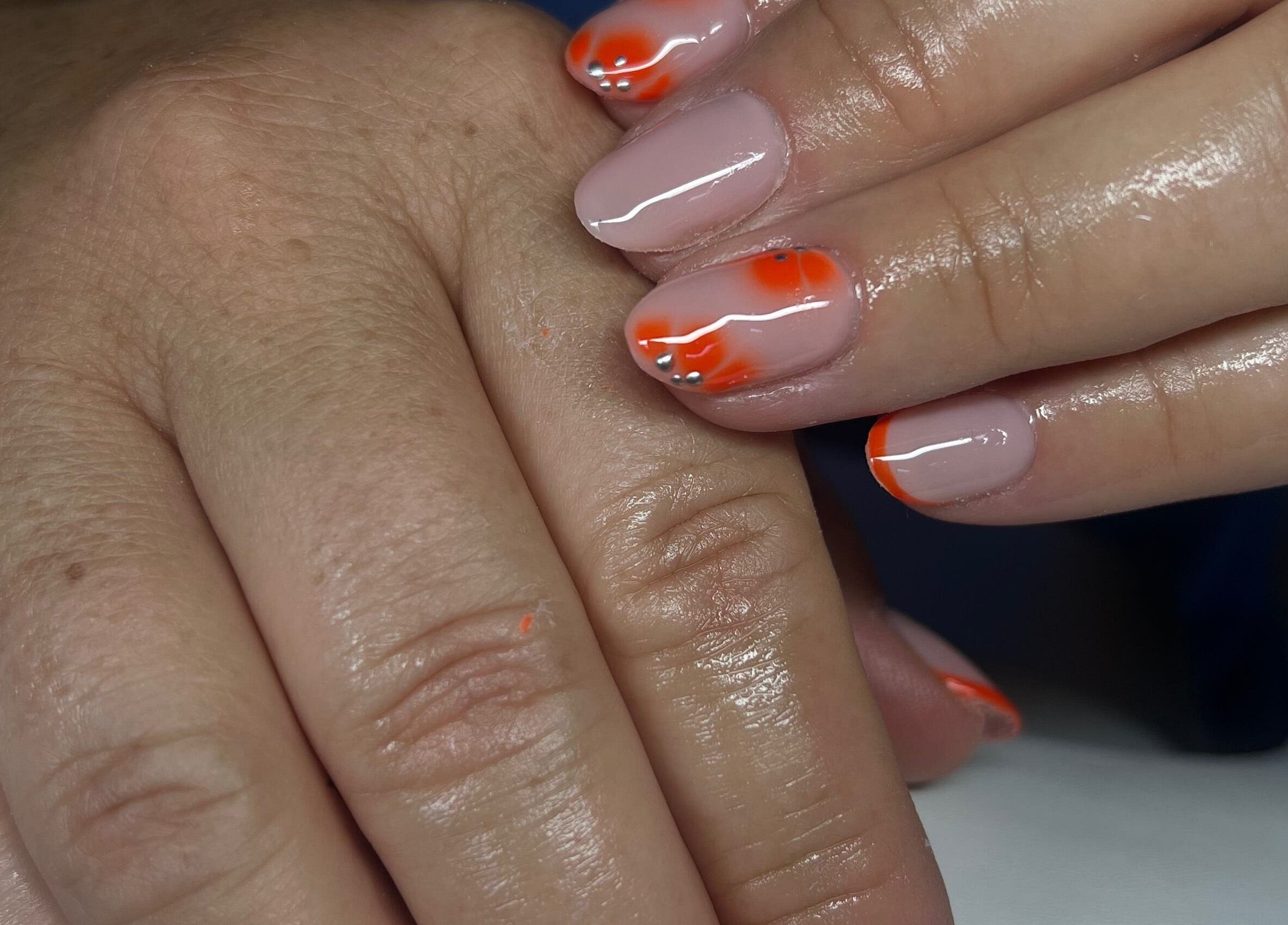 Stylish orange-tipped nails from Nails by Cat, Cambuslang, Scotland, GB. Detailed nail art and glossy finish.