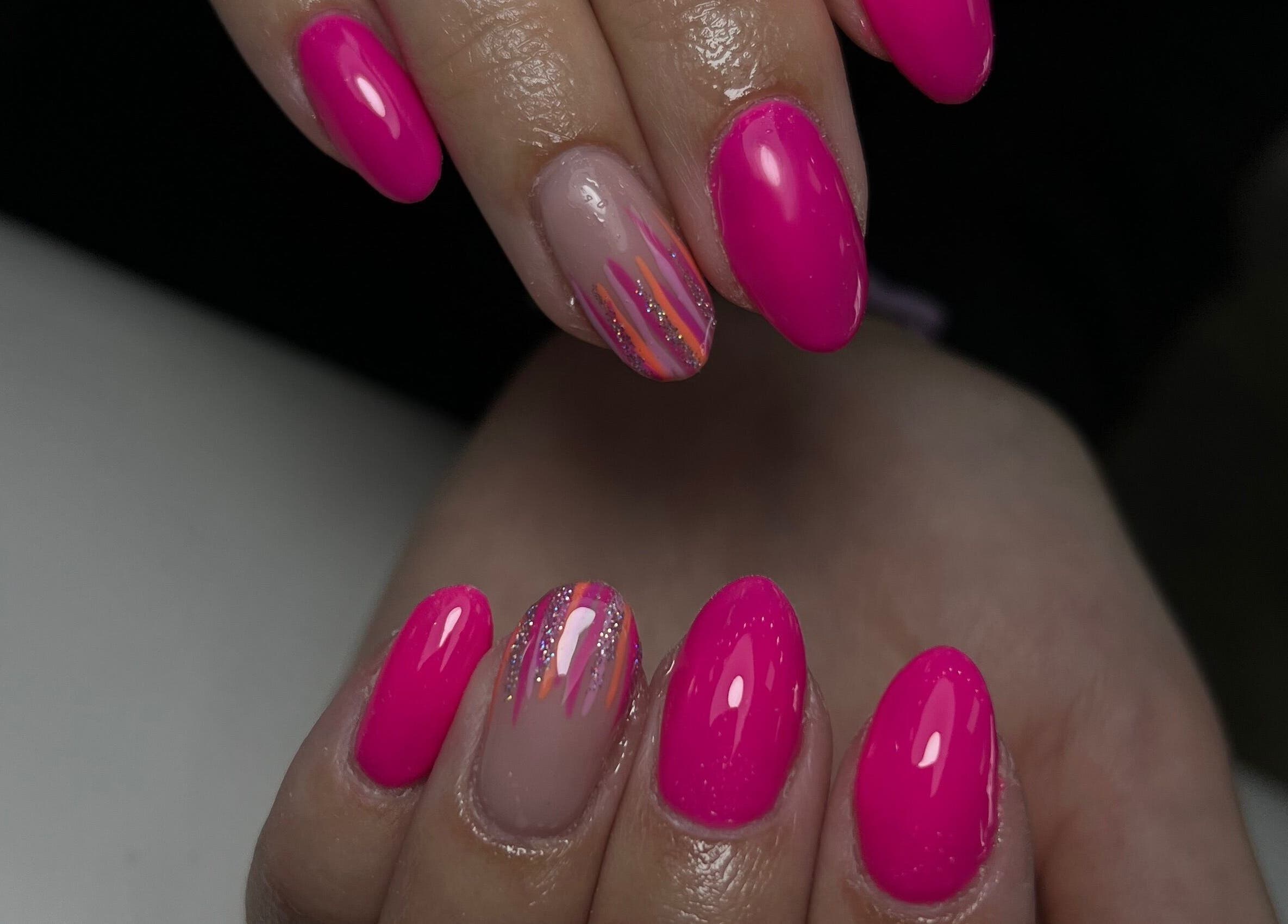 Vibrant pink nails with glitter accents at Nails by Cat, Cambuslang, Scotland, GB. Expertly crafted designs.
