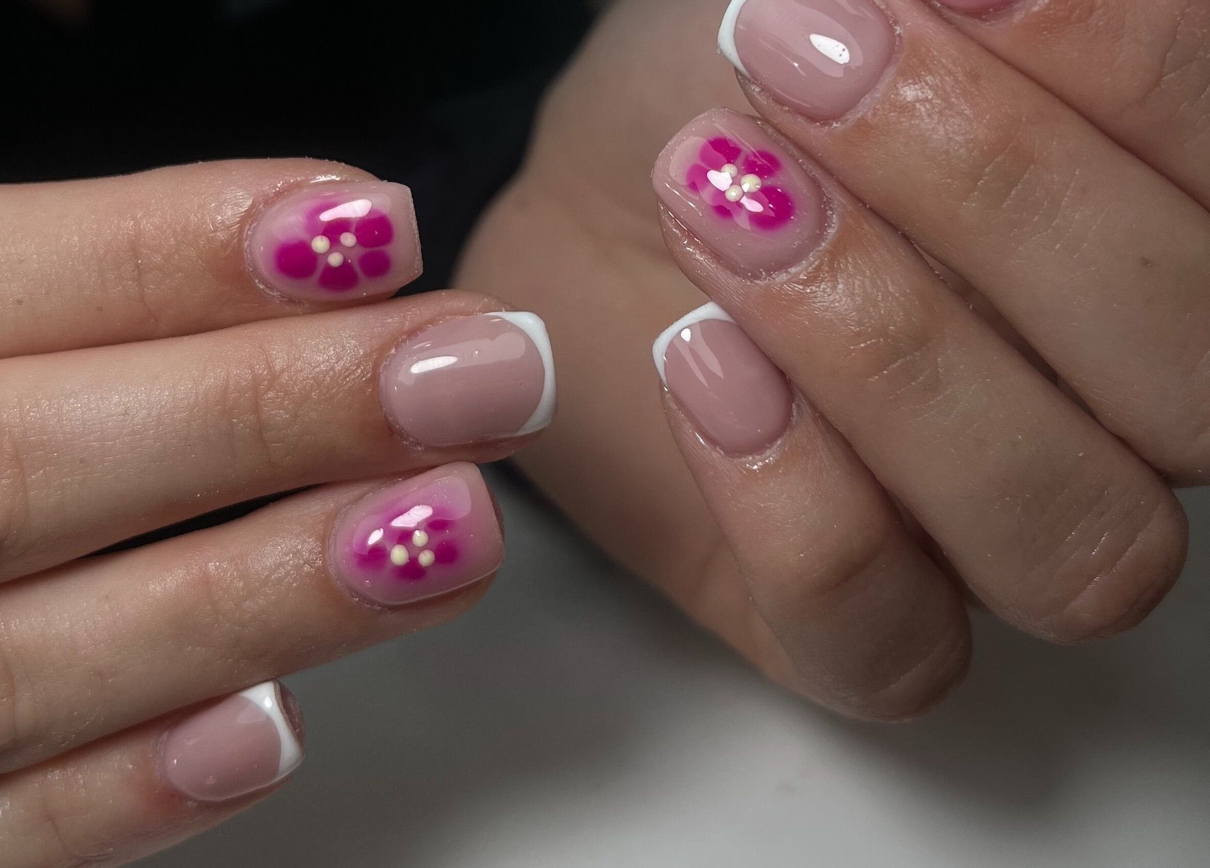 Floral nail art at Nails by Cat, Cambuslang, Scotland, GB. Elegant pink and white flower designs on fingers.