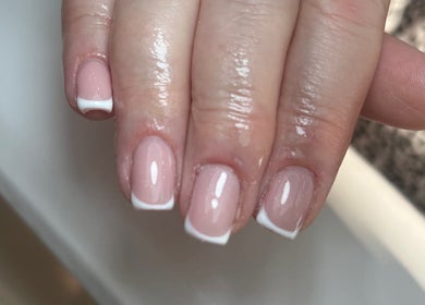 Close-up of a French manicure at Nails by Cat, Cambuslang, Scotland, GB. Features glossy nails with white tips.