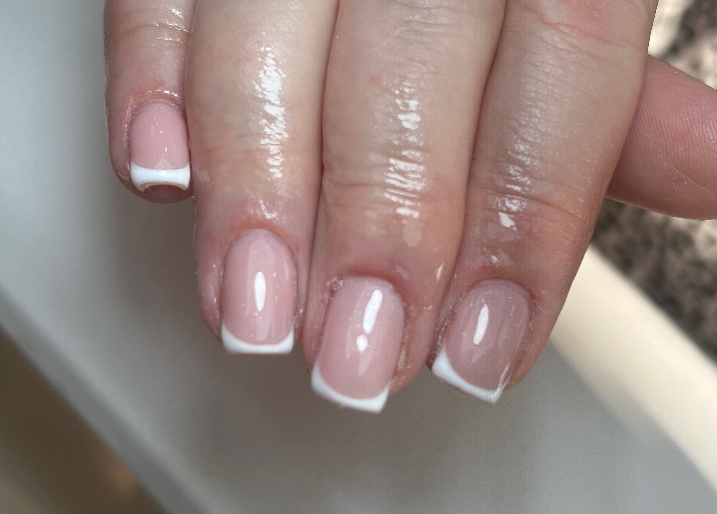 Close-up of a French manicure at Nails by Cat, Cambuslang, Scotland, GB. Features glossy nails with white tips.