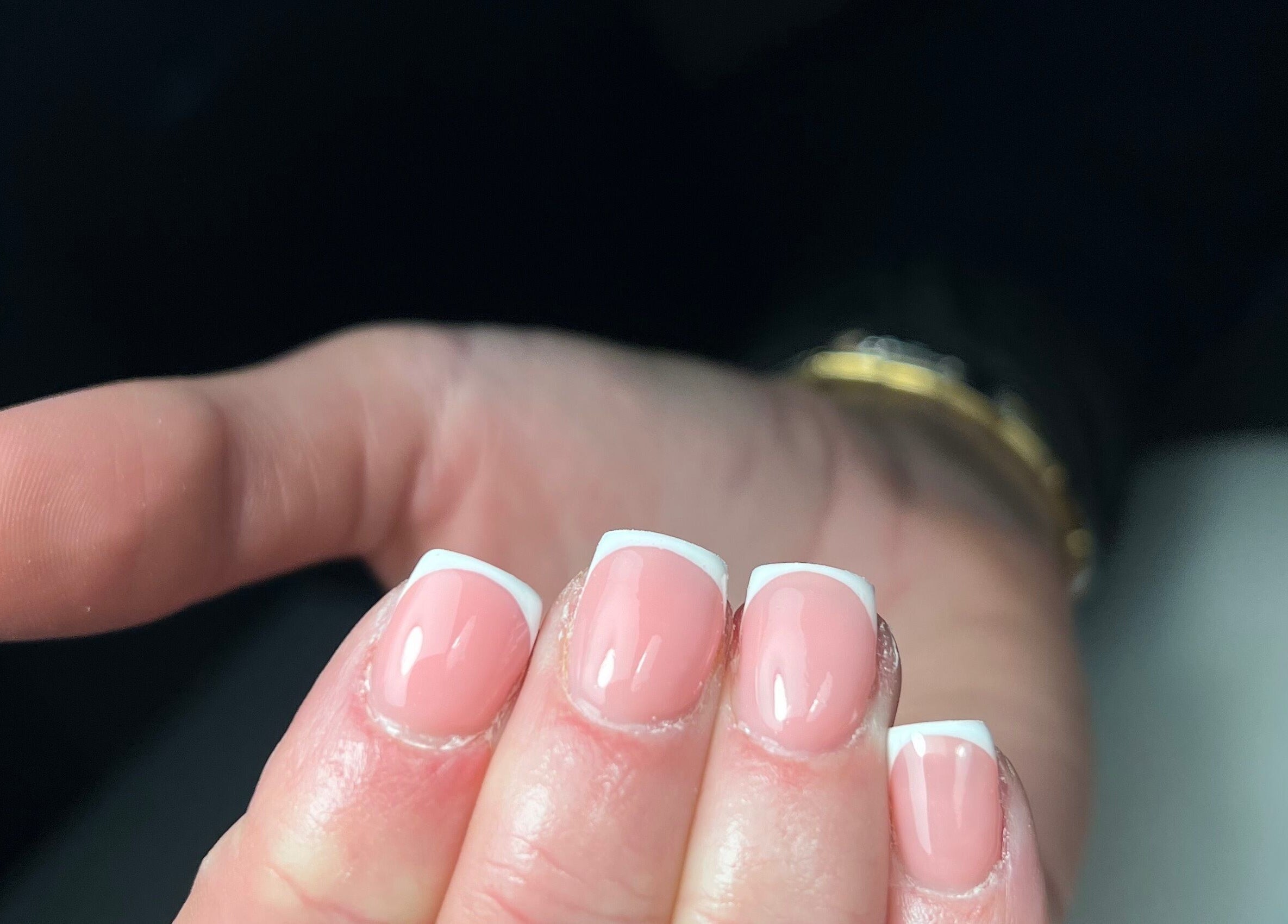Elegant French manicure at Nails by Cat in Cambuslang, Scotland, GB. Perfectly polished nails displayed attractively.
