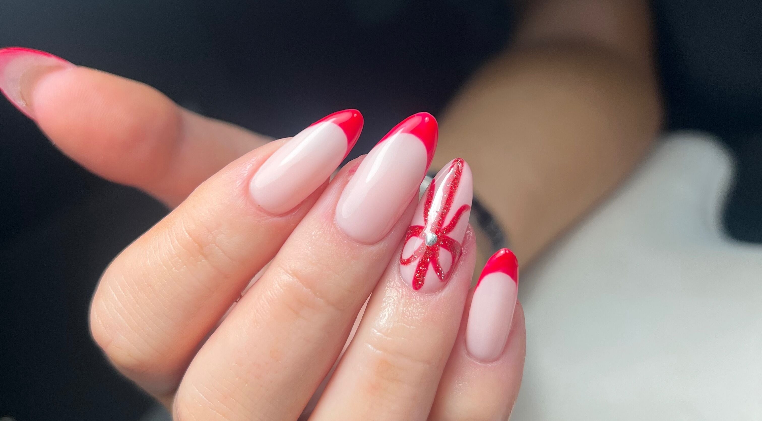 Elegant red-tipped nails with designs at Nails by Cat, Cambuslang, Scotland, GB.