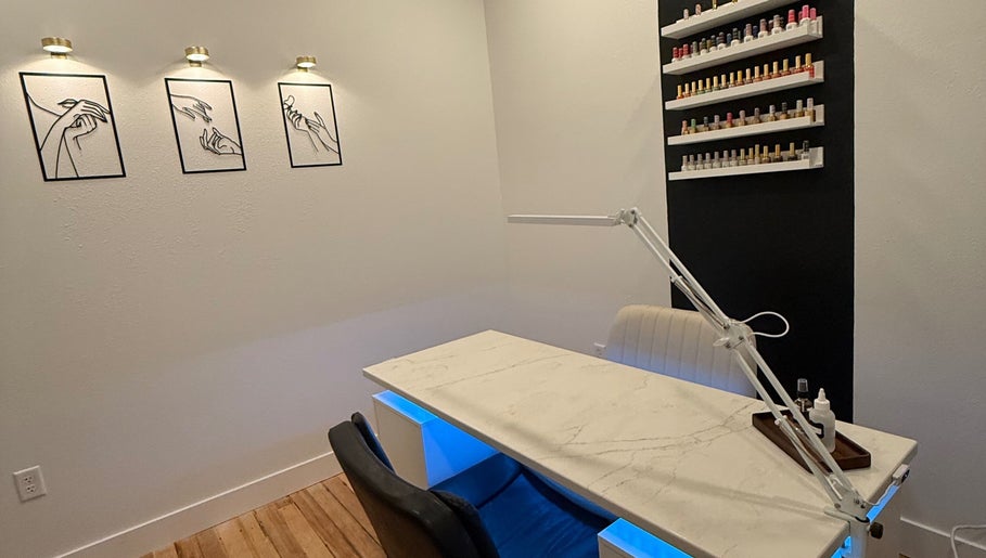 Elegant nail station at Nails by Morgen in Hays, Kansas, US, featuring modern decor and polish display.