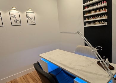 Elegant nail station at Nails by Morgen in Hays, Kansas, US, featuring modern decor and polish display.