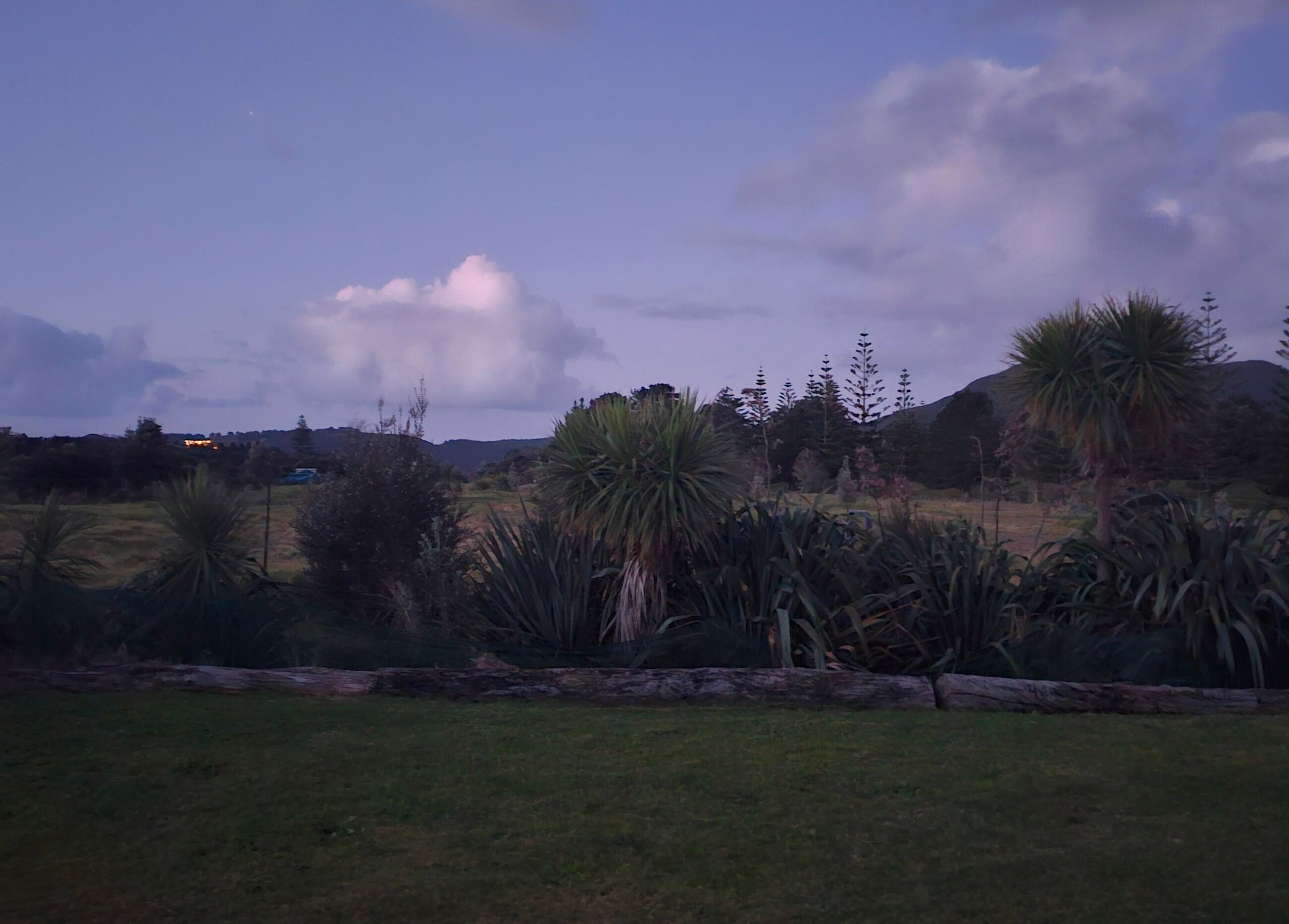 Tranquil twilight view from Wai Ora Spa Therapies, showcasing lush landscape in Pukenui, Northland Region, NZ.