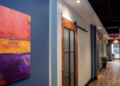 Elegant hallway with colorful art at Thee Slay Babe in Sandy Springs, Georgia, US.