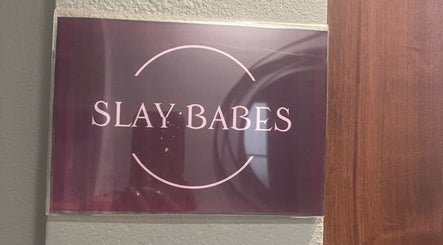 Entrance sign for Thee Slay Babe in Sandy Springs, Georgia, US, featuring elegant logo design.