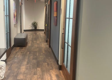 Stylish hallway at Thee Slay Babe, Sandy Springs, Georgia, US with modern decor and wooden flooring.