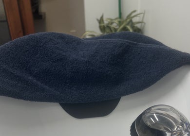 Navy towel elegantly draped over a pristine sink at Thee Hair Slayer in Sandy Springs, Georgia, US.