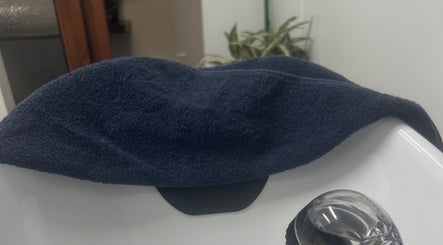 Navy towel elegantly draped over a pristine sink at Thee Hair Slayer in Sandy Springs, Georgia, US.