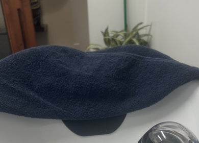 A neatly folded navy towel atop a salon sink at Thee Hair Slayer in Sandy Springs, Georgia, US.