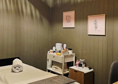 Serene spa room at Elysian Beauty, Winton, Southland Region, NZ with massage bed and calming decor.
