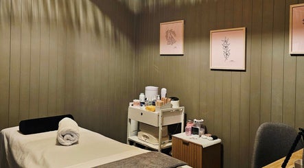 Serene spa room at Elysian Beauty, Winton, Southland Region, NZ with massage bed and calming decor.