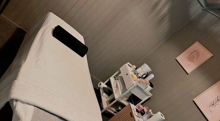 Calm treatment room at Elysian Beauty, Winton, Southland Region, NZ with a massage table and beauty products.
