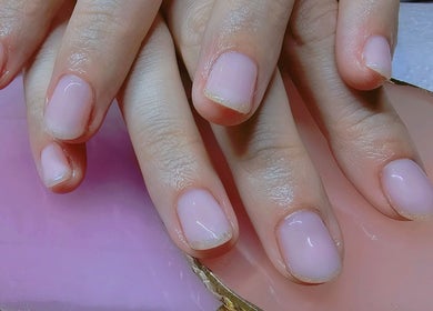 Elegant manicured hands at Elysian Beauty, Winton, Southland Region, NZ, with a soft pink nail polish.
