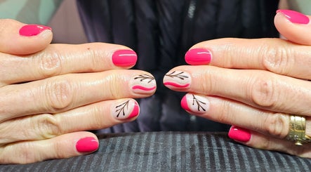 Elegant nail art at Elysian Beauty, Winton, Southland Region, NZ, featuring pink and artful designs.