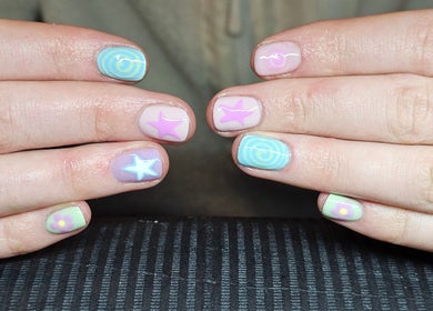 Colorful nail art design at Elysian Beauty in Winton, Southland Region, NZ featuring stars and flowers.