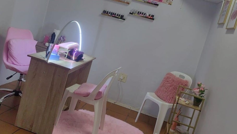 STYLETTE'S nail salon in George, Western Cape, ZA. Cozy setup with pink accents and nail polish display.