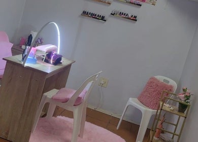STYLETTE'S nail salon in George, Western Cape, ZA. Cozy setup with pink accents and nail polish display.