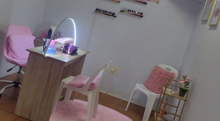 STYLETTE'S nail salon in George, Western Cape, ZA. Cozy setup with pink accents and nail polish display.