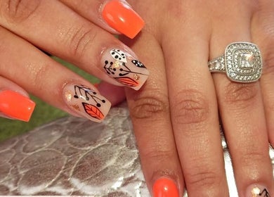 Stylish nail art with orange and leaf designs at STYLETTE'S, George, Western Cape, ZA.
