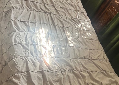 Cozy spa bed with soft white linens at 805 Skin Plug Esthetics, Atascadero, California, US.