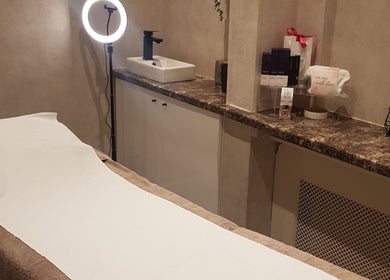 Relaxing treatment room at Beauty by Jade, Wallington, England, GB, featuring a comfortable bed and soft lighting.